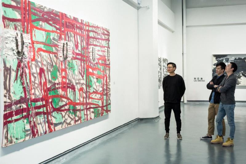 受邀嘉宾在作品前欣赏、交流,多元之下，边缘化的绘画重新激活——当代绘画的五个个案 | 亚洲艺术 · 现场,绘画,之下,亚洲,媒介,杨劲松,厦门磐基艺术馆,开幕式,符号,差别,白盒子艺术馆