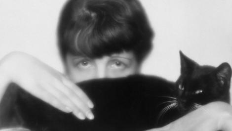 Peeking out shyly, but formidably, from behind a black cat, in a self-portrait from 1929, Dora Kallmus – “Fraulein D’Ora”.jpg